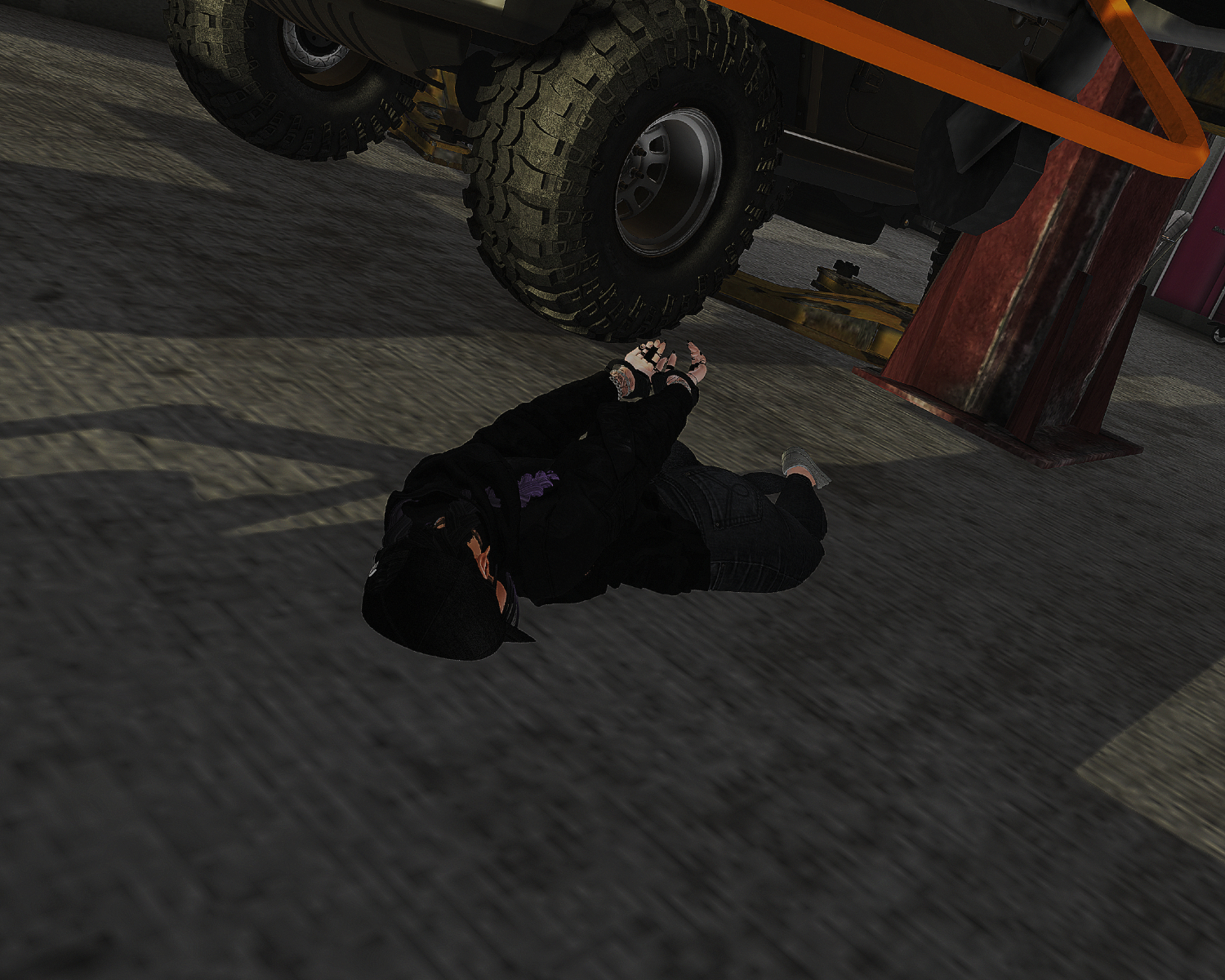 A restrained person lying on the ground beside a vehicle during the aftermath of the Hathian Motors raid.
